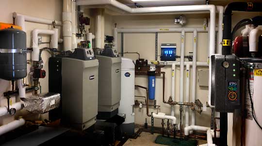 High effciency hot water heating boiler room with wifi thermostat in Lake Tahoe installed by Sunpower Construction.